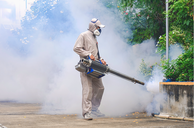 Pest control worker using fogging machine